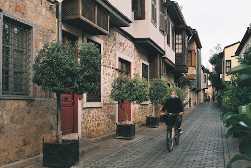 Woman Riding a Bicycle at an Alley