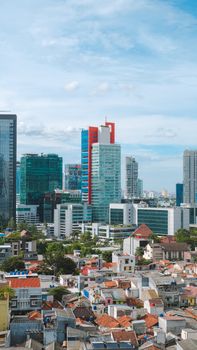 Vibrant city skyline with tall buildings and residential areas below, showcasing urban architecture.