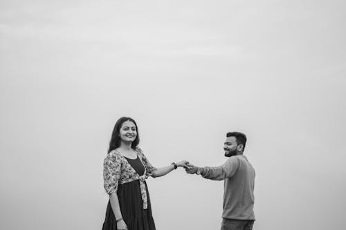 Happy Couple Standing and Holding Hands