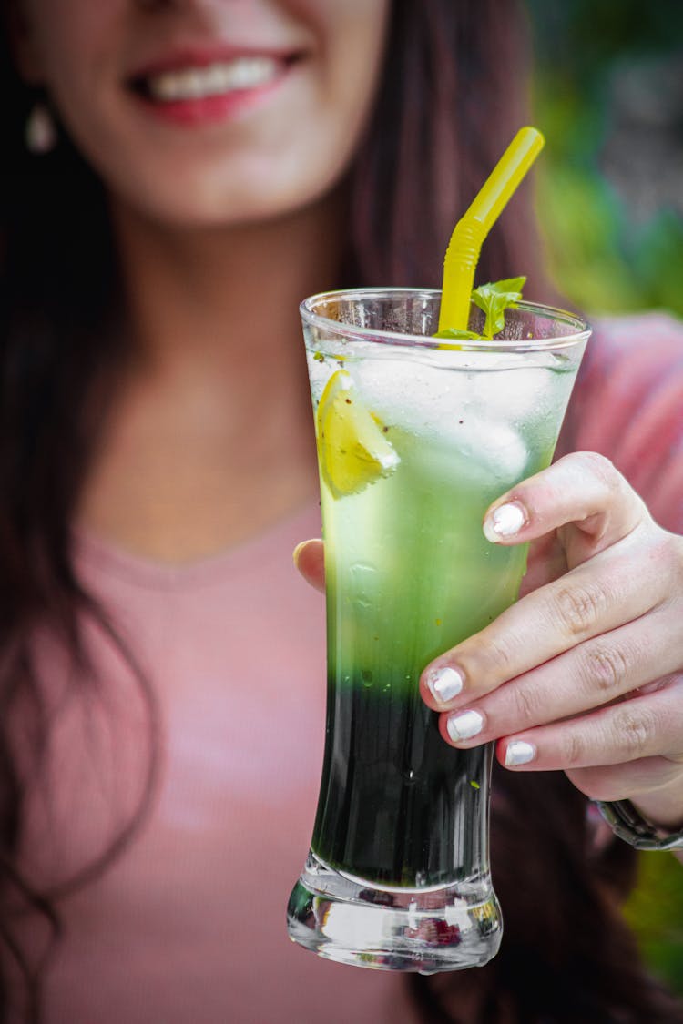 Woman Holding Drink With Straw