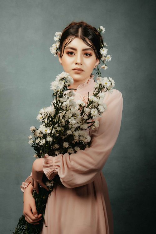 A Woman Holding a Bouquet of White Flowers · Free Stock Photo