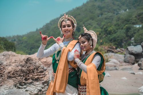 Free Two Odissi dancers pose in traditional costume outdoors in Puri, India. Stock Photo