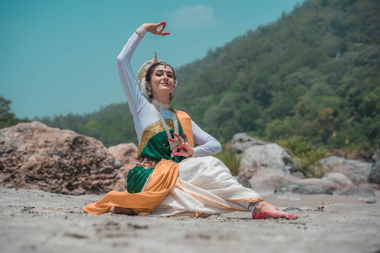 Woman Performing Traditional Dance On The Beach