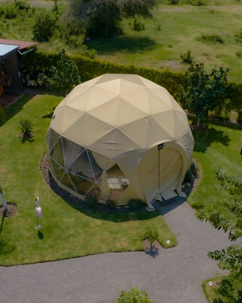 Free Geodesic dome nestled in lush greenery, captured in an aerial shot in Santa Lucía Cosamaloapan, Mexico. Stock Photo