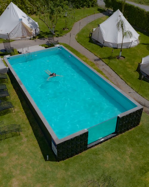 Photo of a Woman Swimming in a Swimming Pool