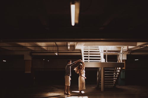 A Man and a Woman Dancing Near a Staircase