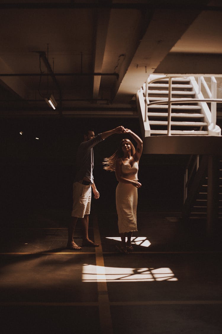 Photo Of A Couple Dancing Near A Staircase