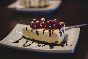 Cheesecake slice with berry sauce — photo by Valeria Boltneva on Pexels