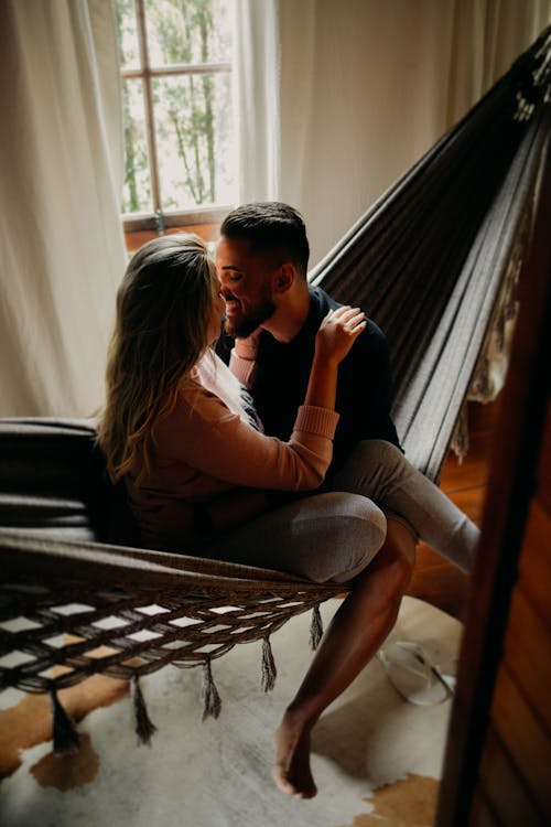 Free A Couple Kissing on a Hammock Stock Photo