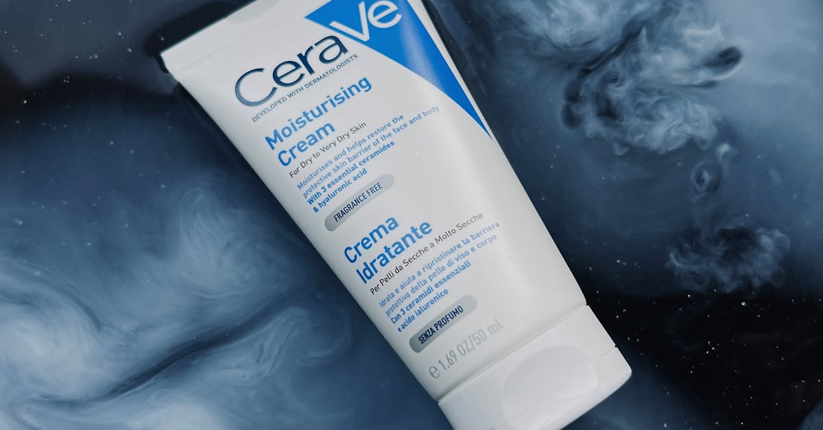 A woman applying a non-comedogenic moisturizer to her face.