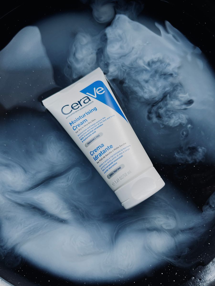 CeraVe Moisturising Cream tube on a swirling blue and white background