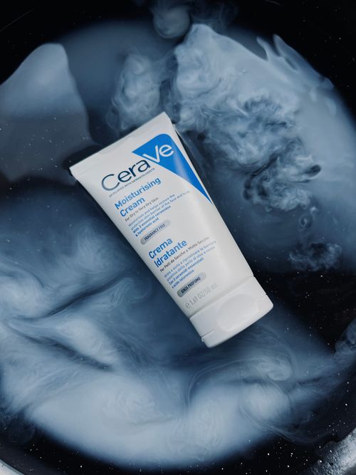 Free CeraVe Moisturising Cream displayed on a swirling abstract blue and white background. Stock Photo