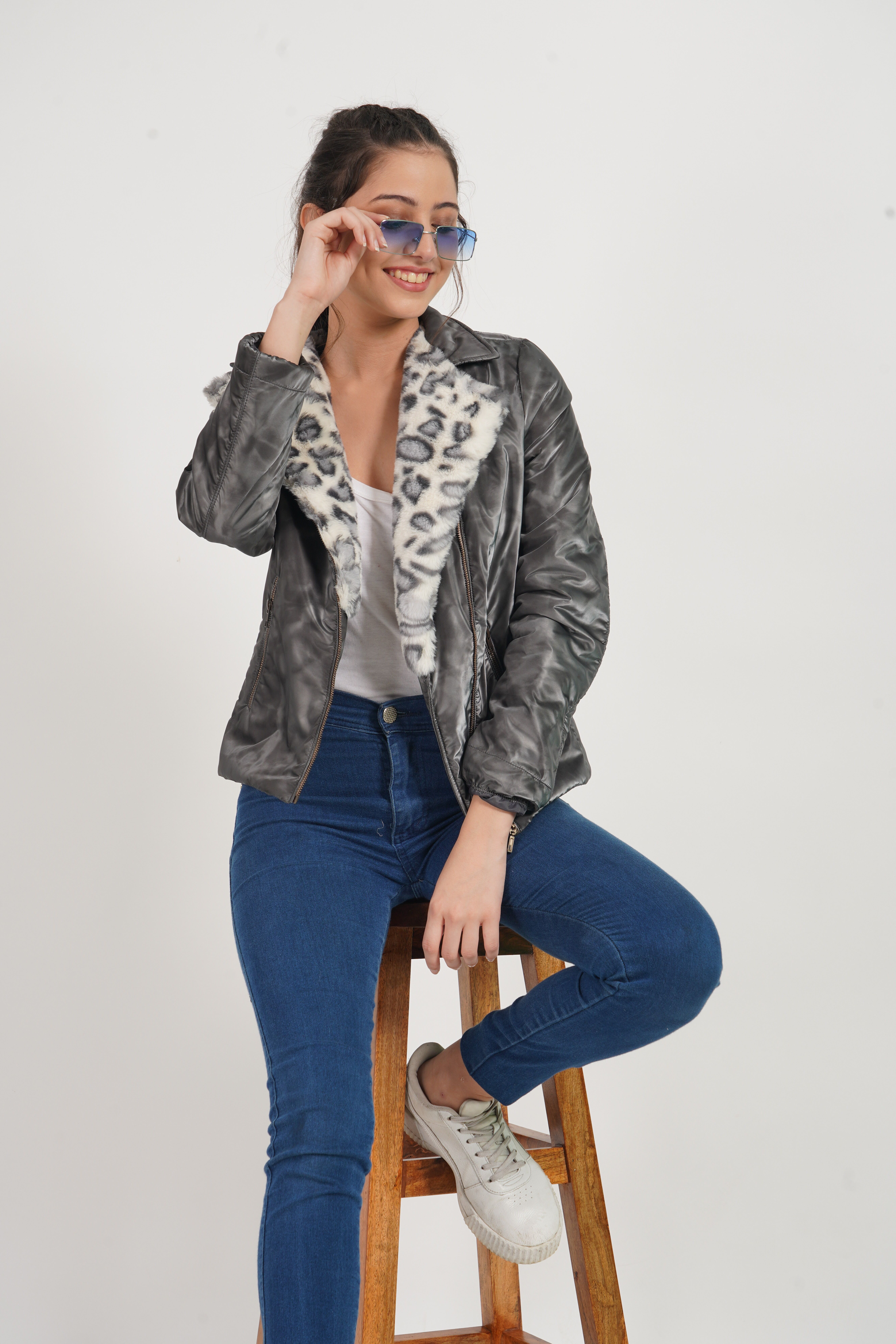 Woman in Black Leather Jacket and Blue Denim Jeans Sitting on Wooden ...