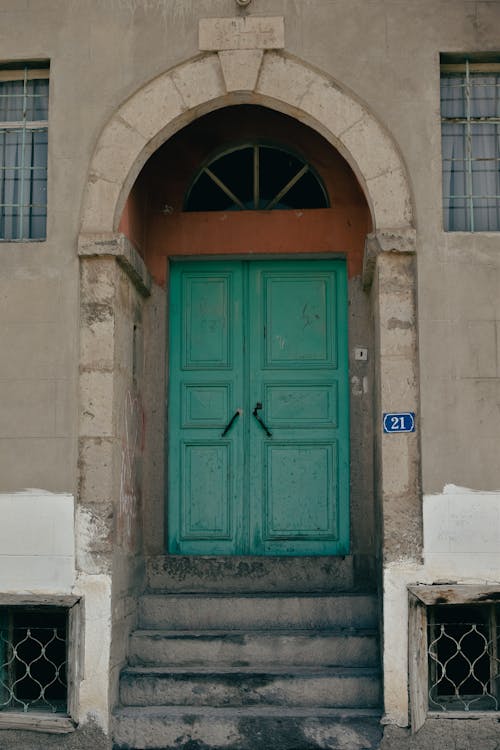 A Wooden Door with Perron Between Concrete Walls
