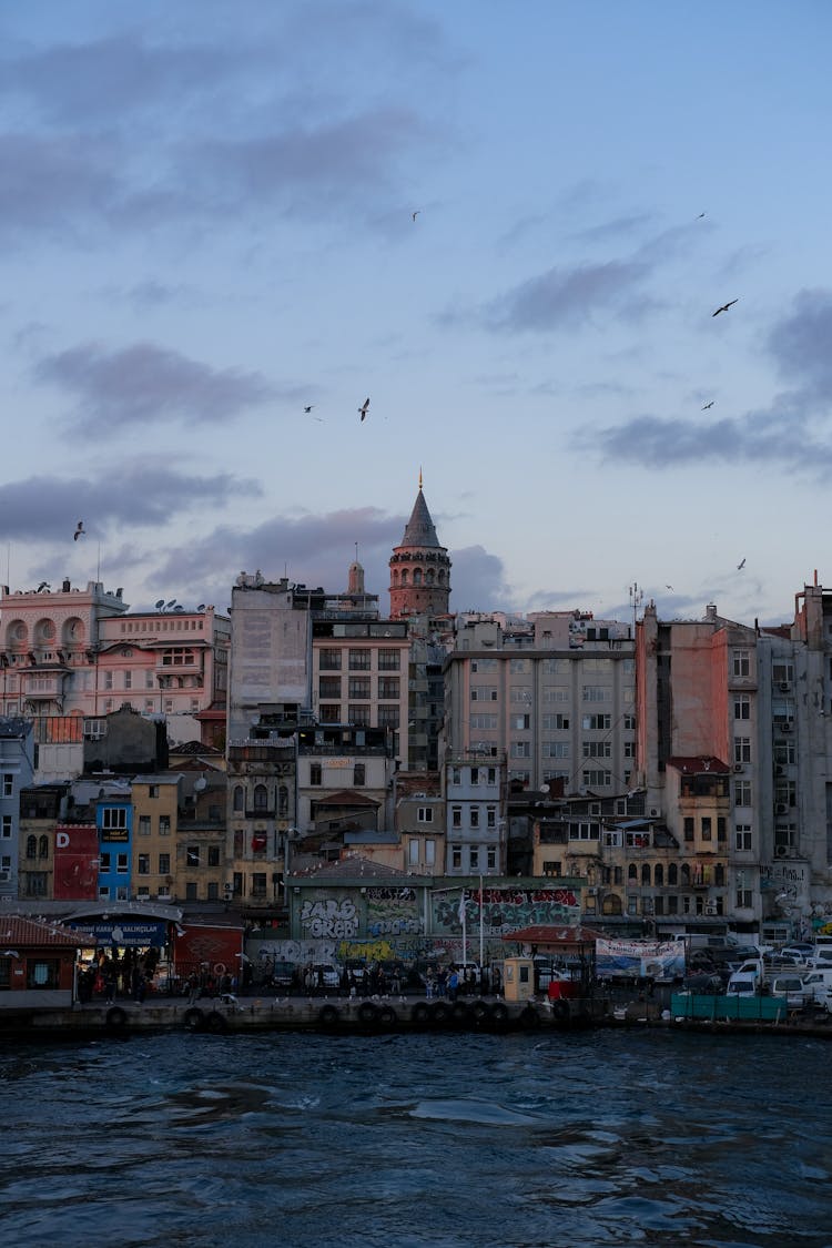 Town Waterfront With A Tower At Dusk