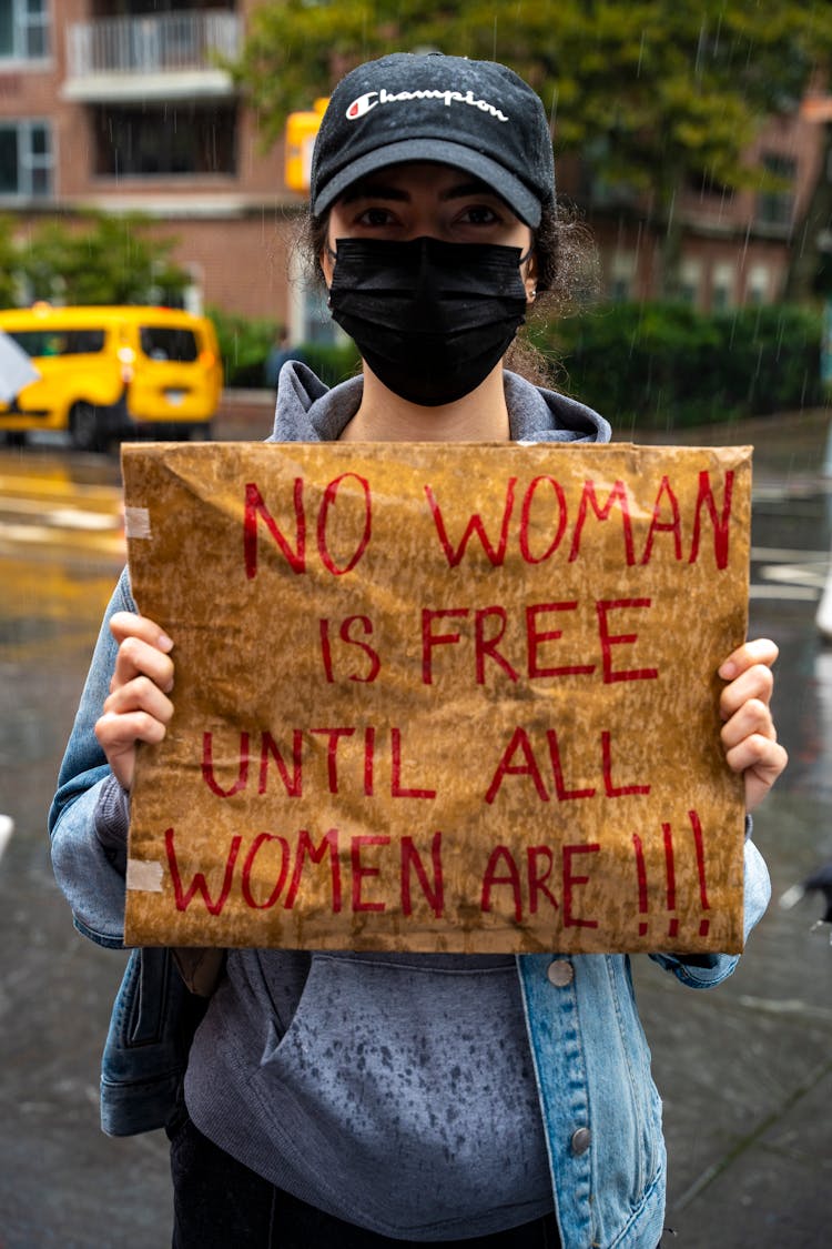 A Woman Holding A Poster