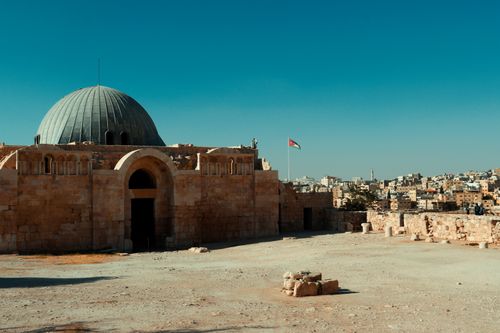 Free View of the Umayyad Palace and Amman skyline under a clear blue sky. Stock Photo