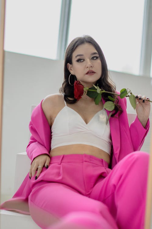 Free A Woman Holding a Red Rose  Stock Photo