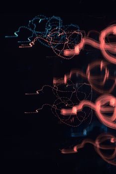Vibrant abstract light patterns with red and blue on a dark background, creating a dynamic visual effect.