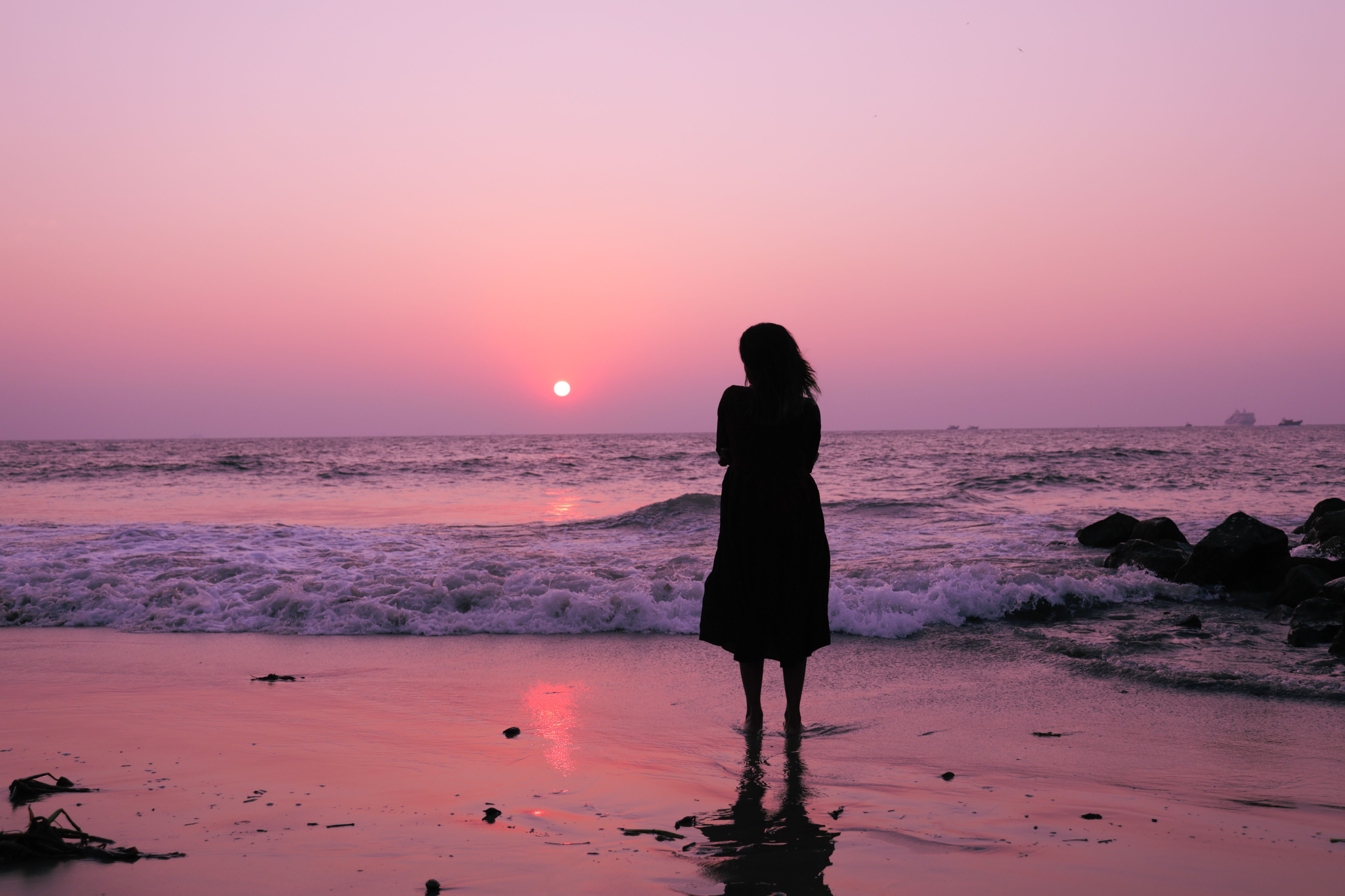 Silhouette of Woman Standing at the Beach · Free Stock Photo