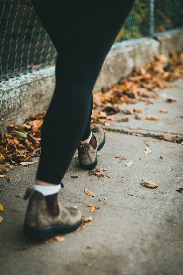 Walking On Sidewalk In Autumn