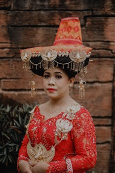 Woman in vibrant red traditional Karo attire, showcasing cultural elegance.