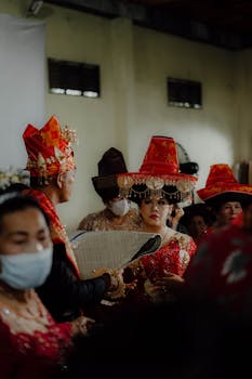 A vibrant scene depicting a traditional Indonesian ceremony with participants in elaborate cultural attire.