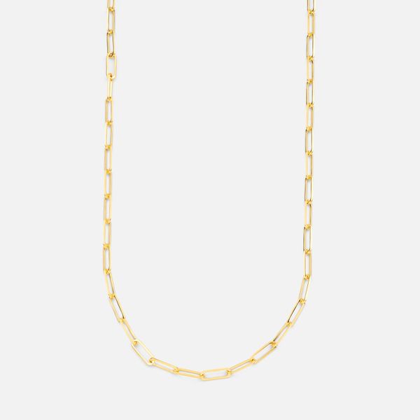 Fine gold chain necklace on a pale background — photo by The Glorious Studio on Pexels