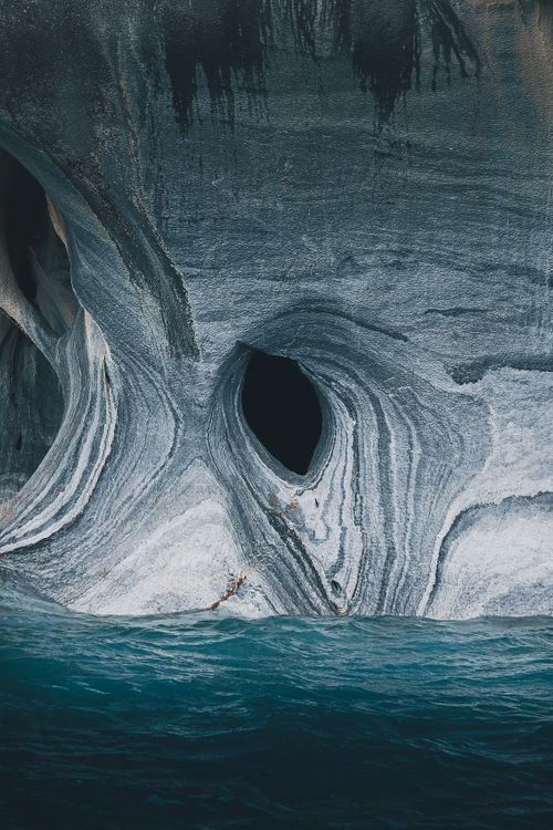 Free Beautiful marble formations emerge from a turquoise sea, showcasing nature's artistry. Stock Photo