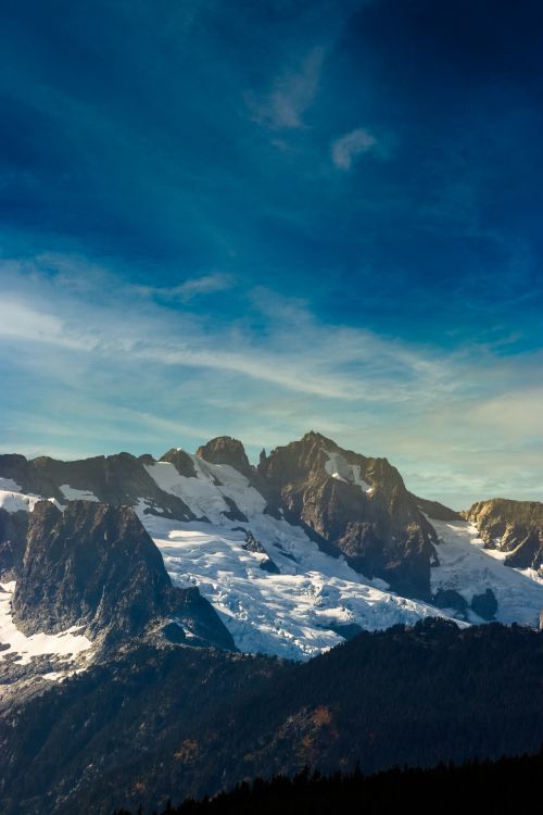 Free Breathtaking view of snowy mountains under a blue sky in Squamish, BC, Canada. Stock Photo