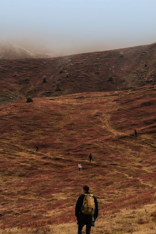 Free Group of hikers in a scenic autumn landscape in Shkodër, Albania. Misty hills create a serene atmosphere. Stock Photo