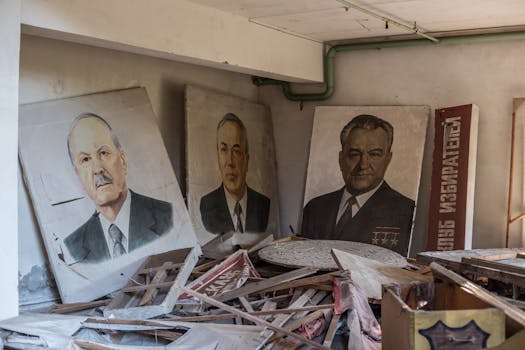Vintage portraits in an abandoned room full of wooden debris, evoking a sense of history.