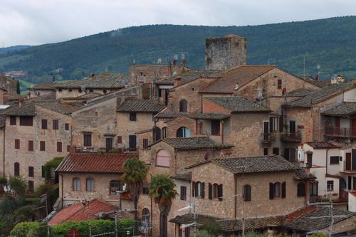 Free A picturesque view of a historic Italian town with ancient stone architecture. Stock Photo
