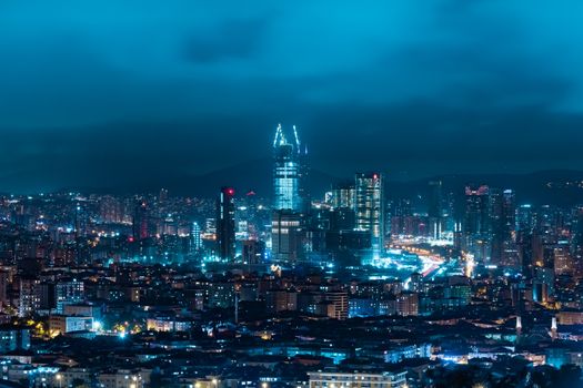 Captivating nighttime view of İstanbul's illuminated skyline featuring modern skyscrapers and city lights.