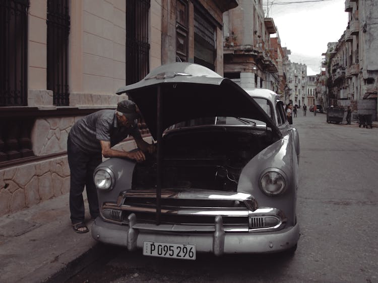 A Man Fixing A Vintage Car