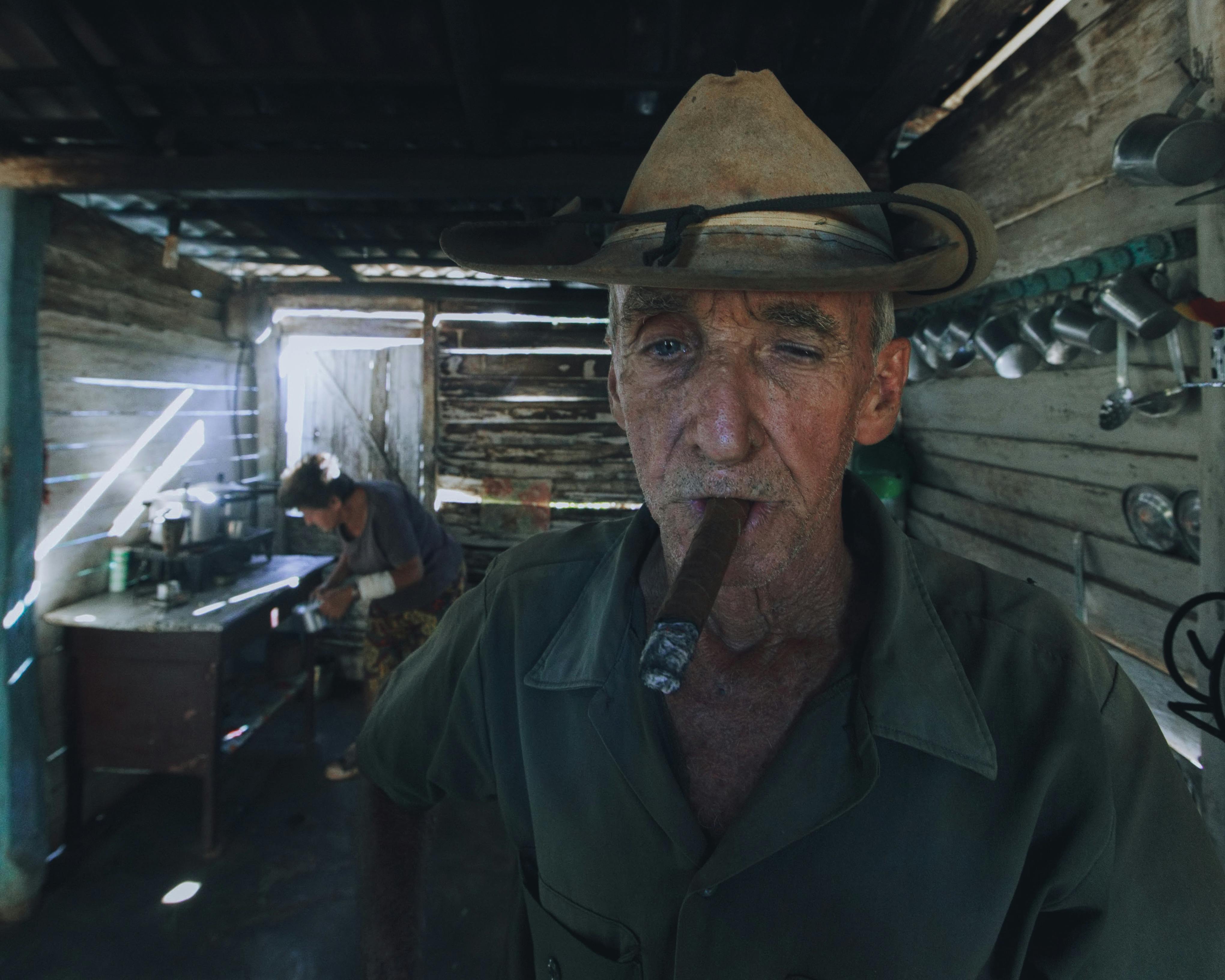Elderly Man Wearing Cowboy Hat Smoking Cigar · Free Stock Photo