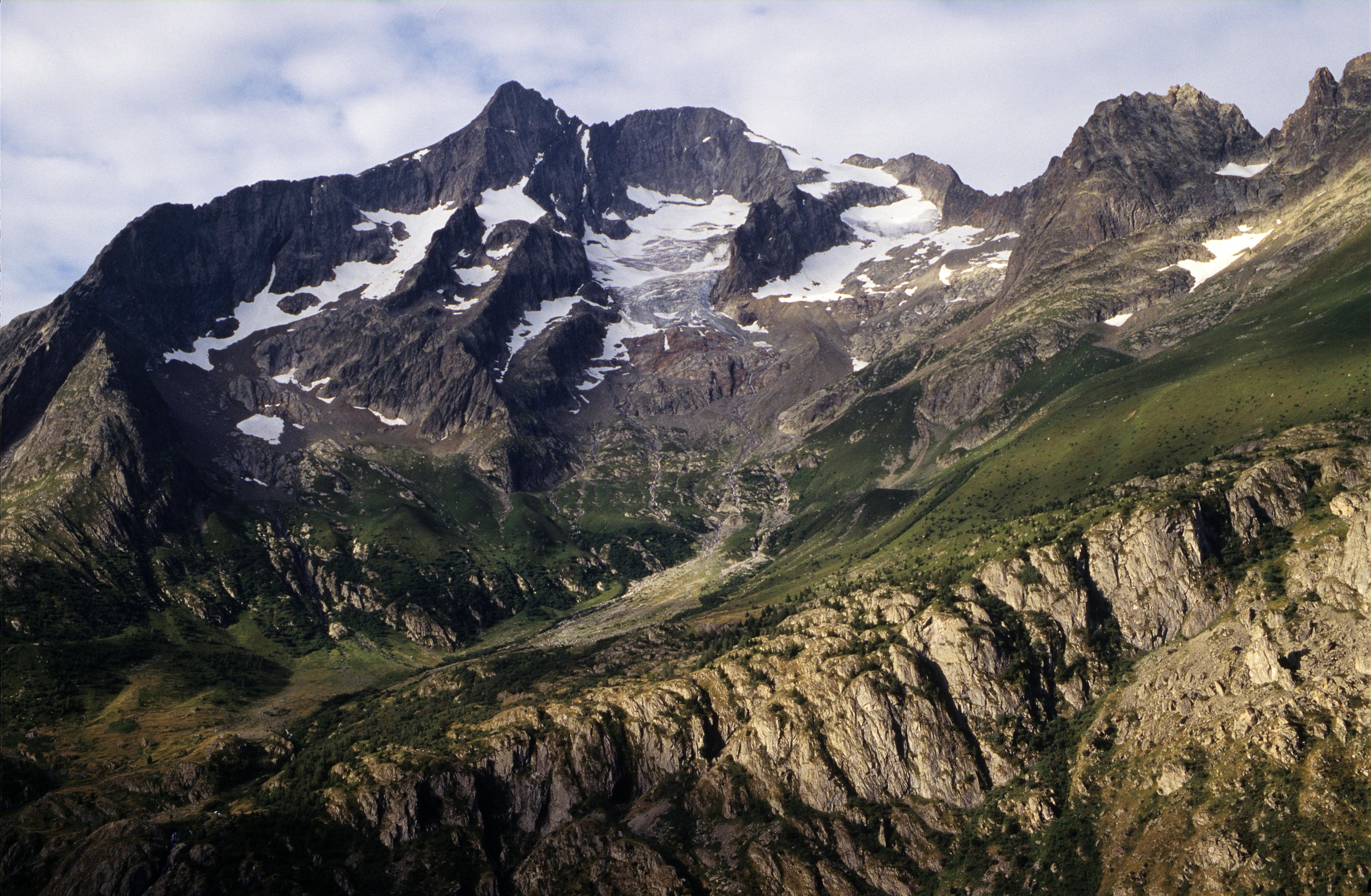 Scenic view of mountain peaks and snow in Saint-Christophe-en-Oisans, France.