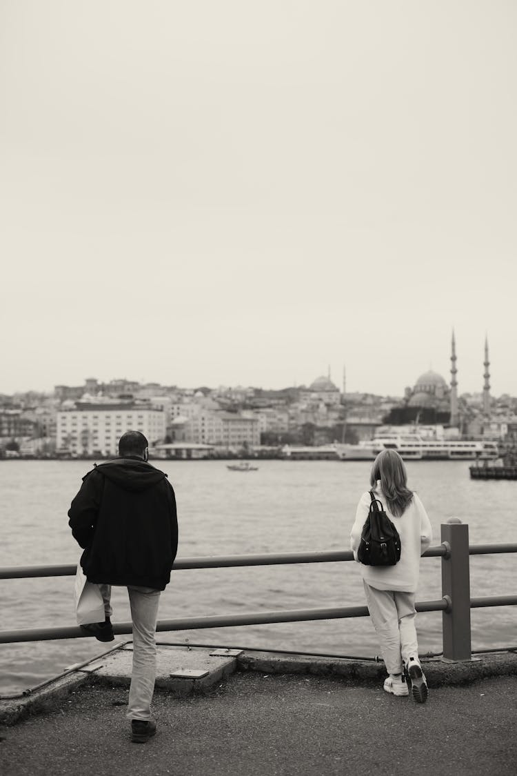 Back View Of A Man And Woman Enjoying The City Skyline View