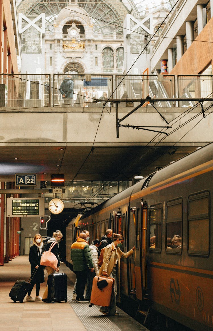 People Boarding A Train In Antwerp Centraal Station