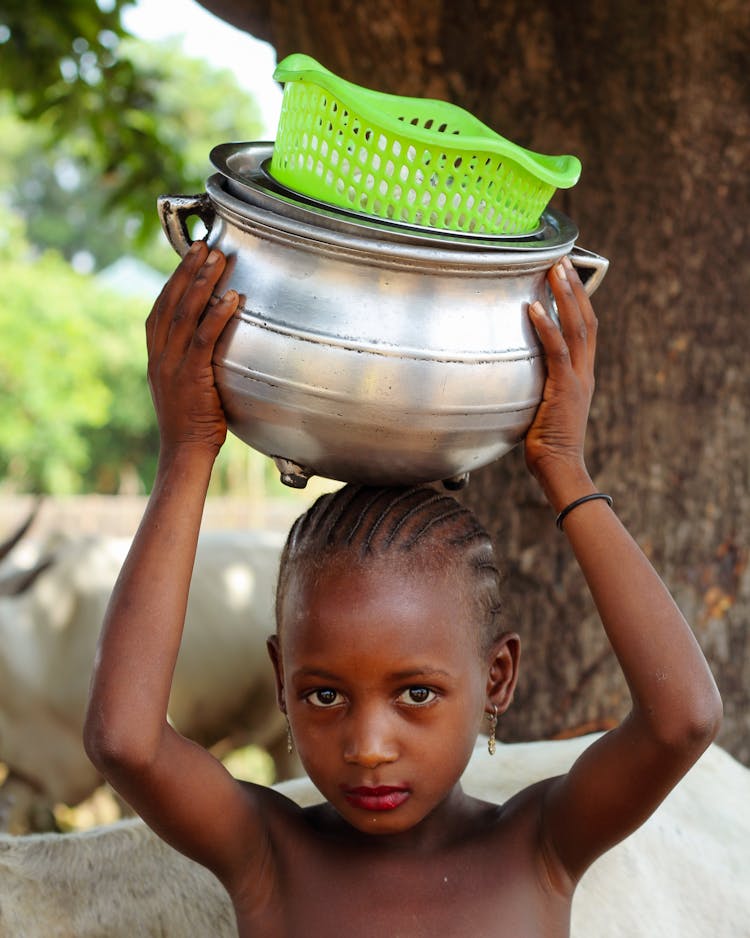 Girl Carrying A Pot On The Head