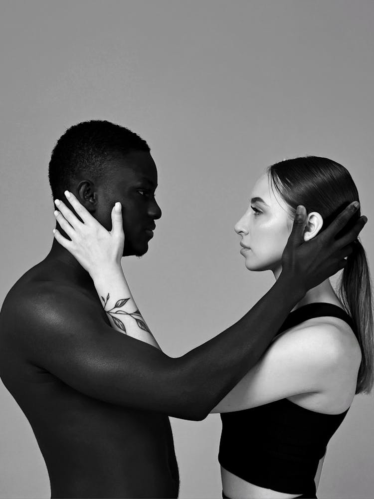 Studio Shoot Of A Black Man And White Woman Embracing Each Other