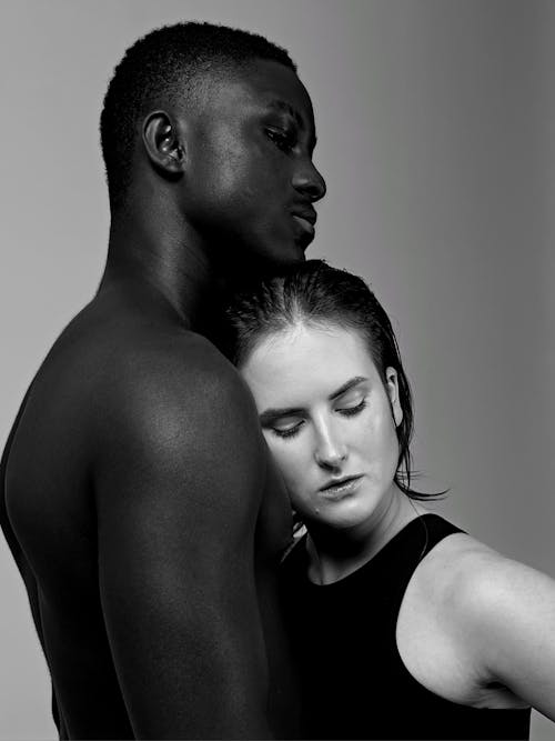 Black and White Photography of Man and Woman Cuddling