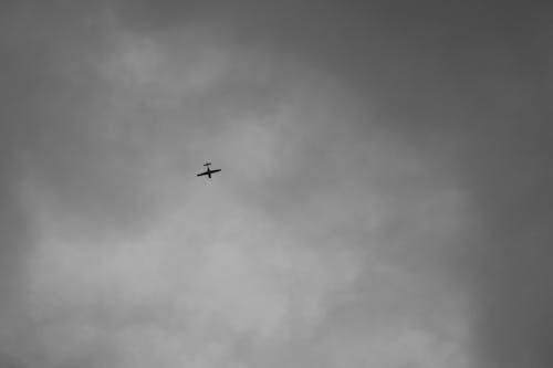 Grayscale Photo of a Plane in the Sky 