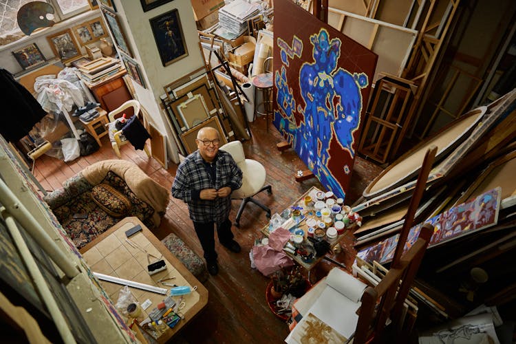 High Angle Wide Angle View Of An Artist In His Studio