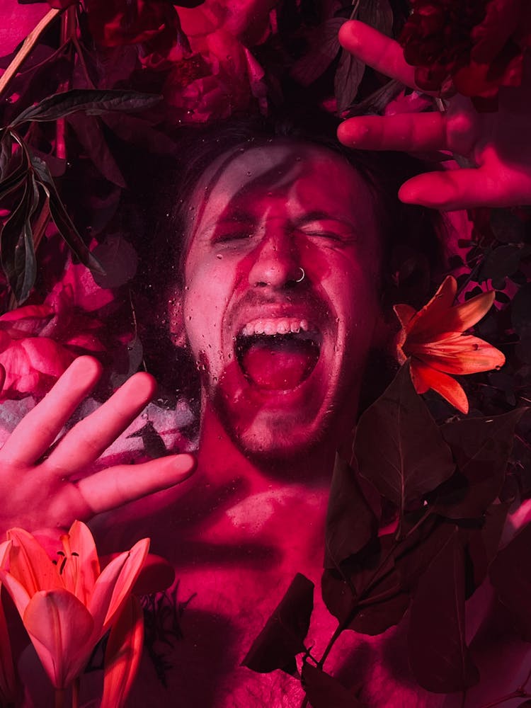 Pink Toned Image Of A Man With Flowers