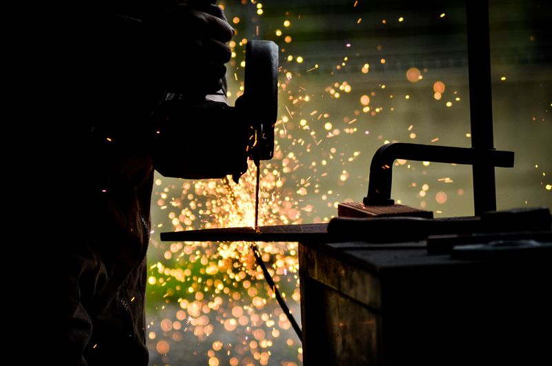 Welder repairing stainless plant equipment