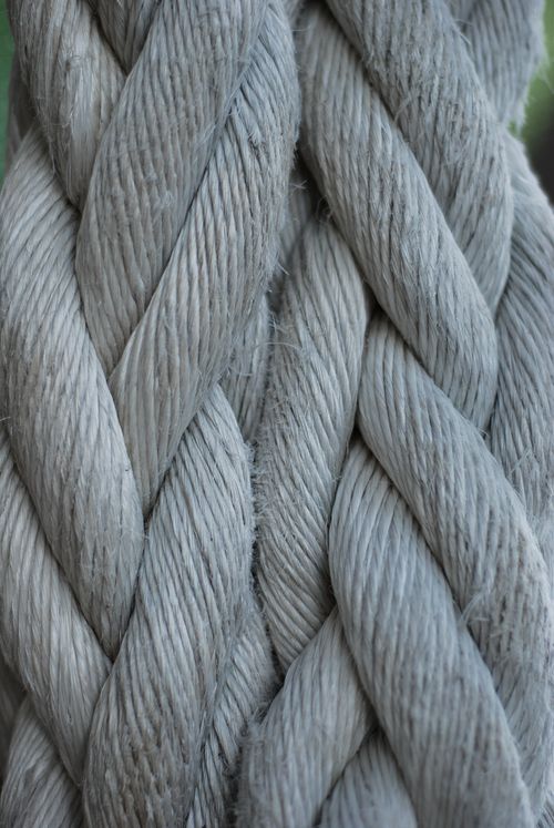 Free Detailed close-up of a twisted grey rope showcasing a rugged texture pattern. Stock Photo