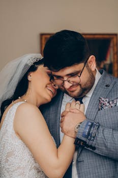 A heartwarming portrait of a newlywed couple embracing and smiling joyfully on their wedding day.
