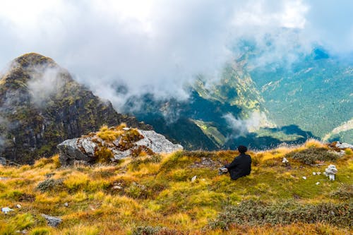 A Person Sitting on the Mountain