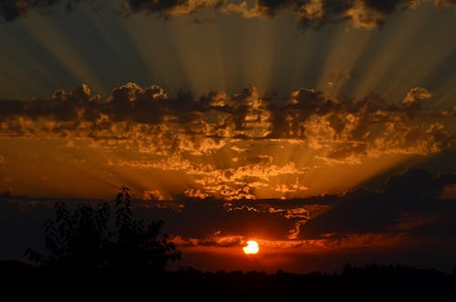 Sunbeams Shining trough Clouds at Sunset